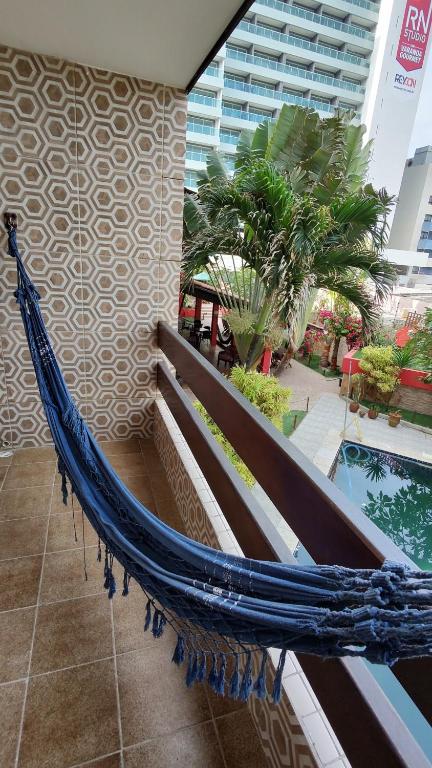 a hammock sitting on the side of a building at Hotel Pousada Bossa Nova in Maceió