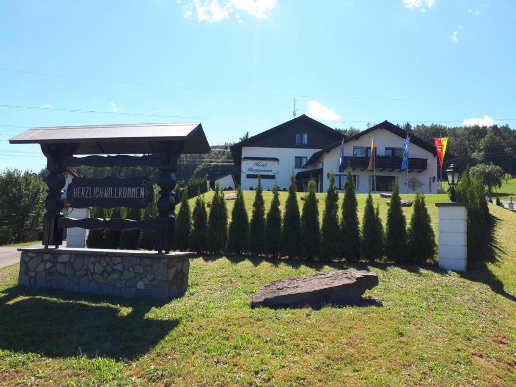 a gazebo with a sign in a yard at Hotel Bergwiesen in Lohr am Main