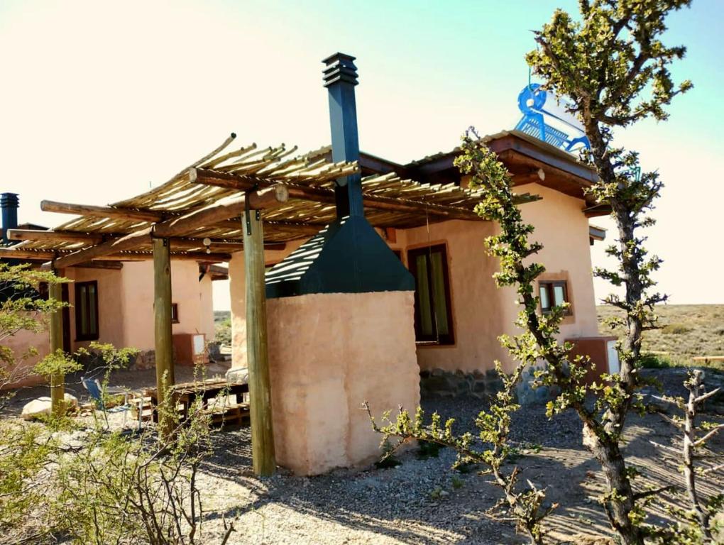 a house in the middle of a desert at CABAÑAS KONDUR Elementos in Ciudad Lujan de Cuyo