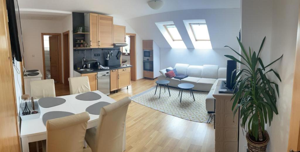 a kitchen and living room with a table and a couch at apartman Happy in Stará Lesná