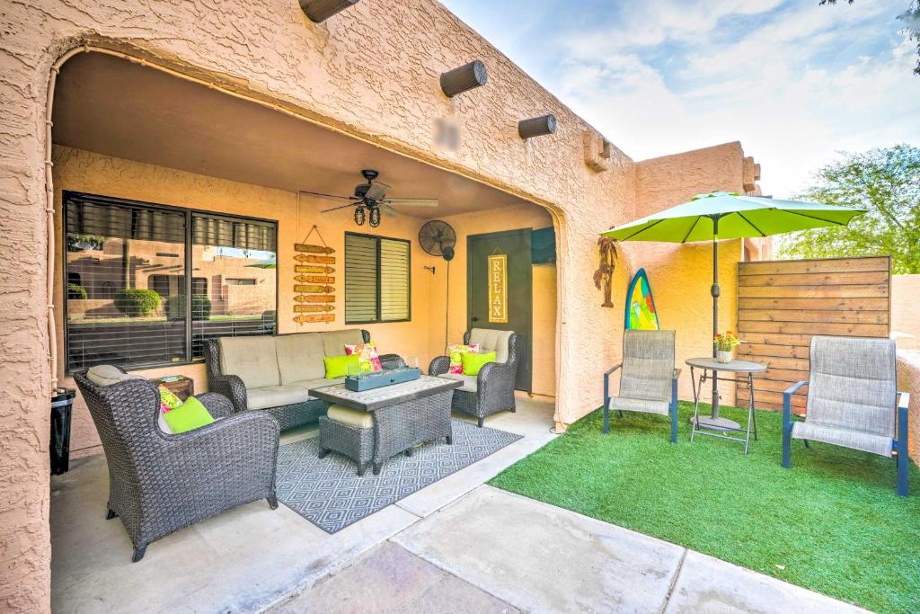 a patio with chairs and an umbrella and a table at Peoria Oasis with Resort Amenities, 2 Mi to Downtown in Peoria