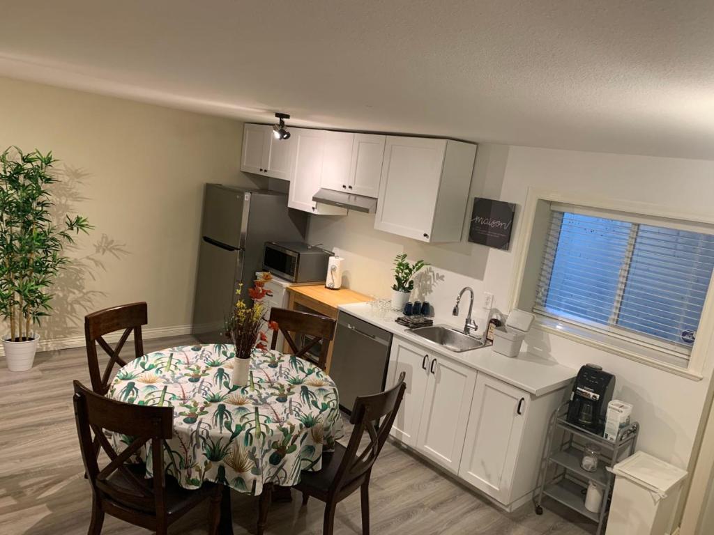 a kitchen and dining room with a table and chairs at Jimmy B&B in Surrey