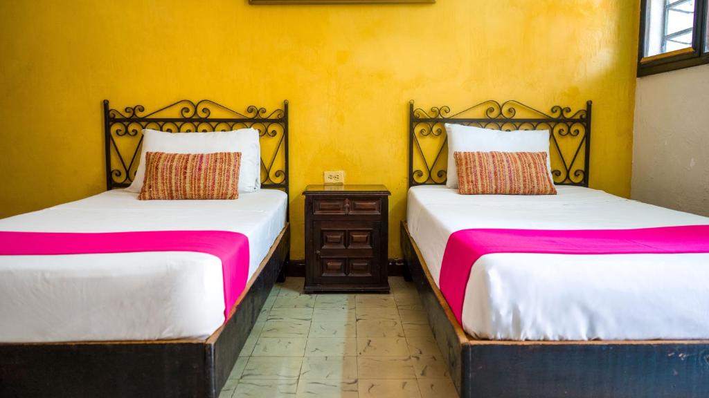 Postel nebo postele na pokoji v ubytování Hotel Mucuy