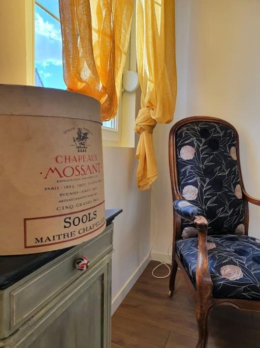 a room with a chair and a box on a dresser at Pavillon d&#39;Aÿ cottage Champagne - Label Green Key in Ay