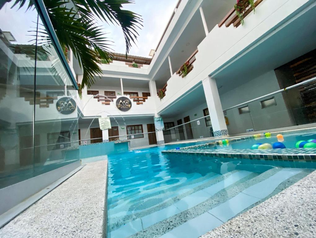 a swimming pool in the middle of a house at Hotel On The Rock in Minca