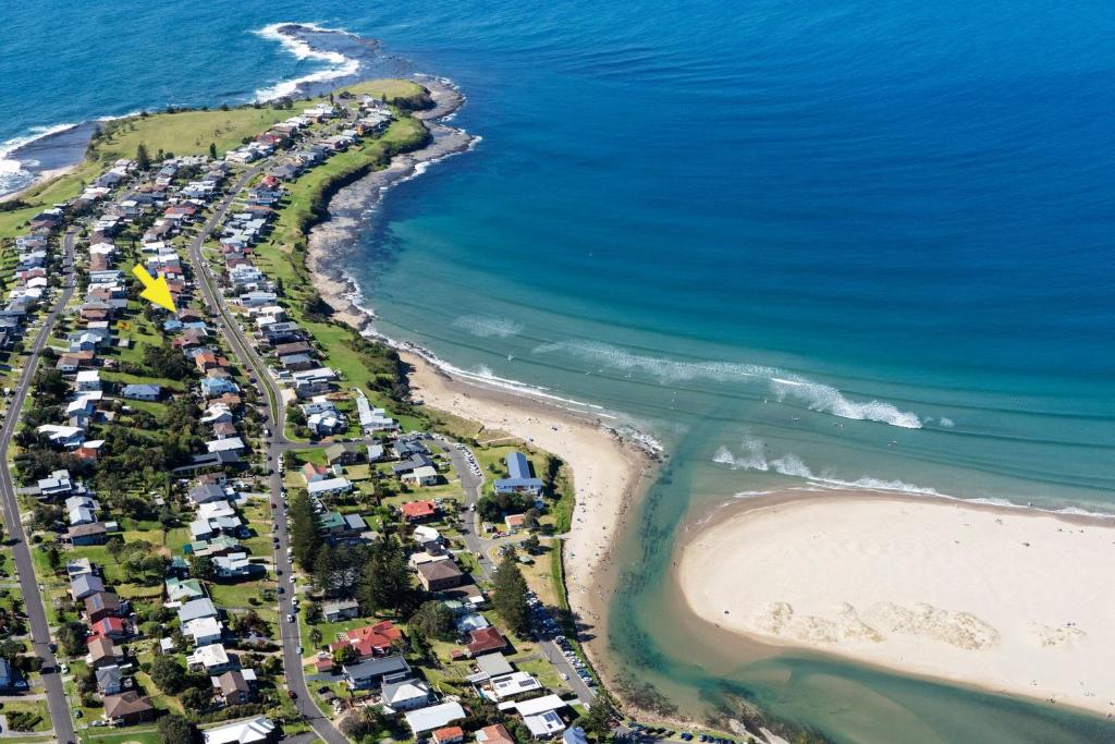 an aerial view of a beach and the ocean at Banksia by the Sea Gerroa in Gerroa