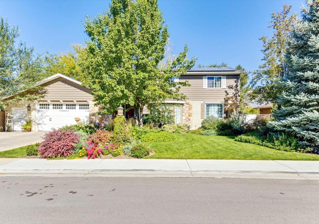 a house with a landscaping in front of a yard at Heart of Orem Basement 3 bedroom Apartment w/ Waffles. in Orem