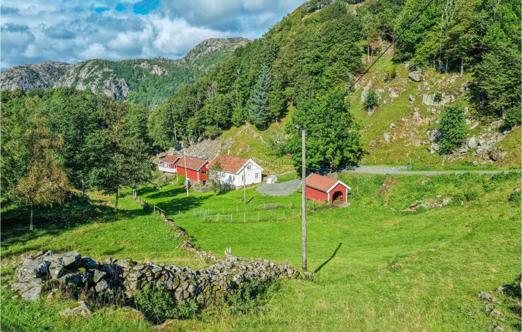 a group of houses on a hill in a field at Amazing Home In Hidrasund With Wifi in Eide