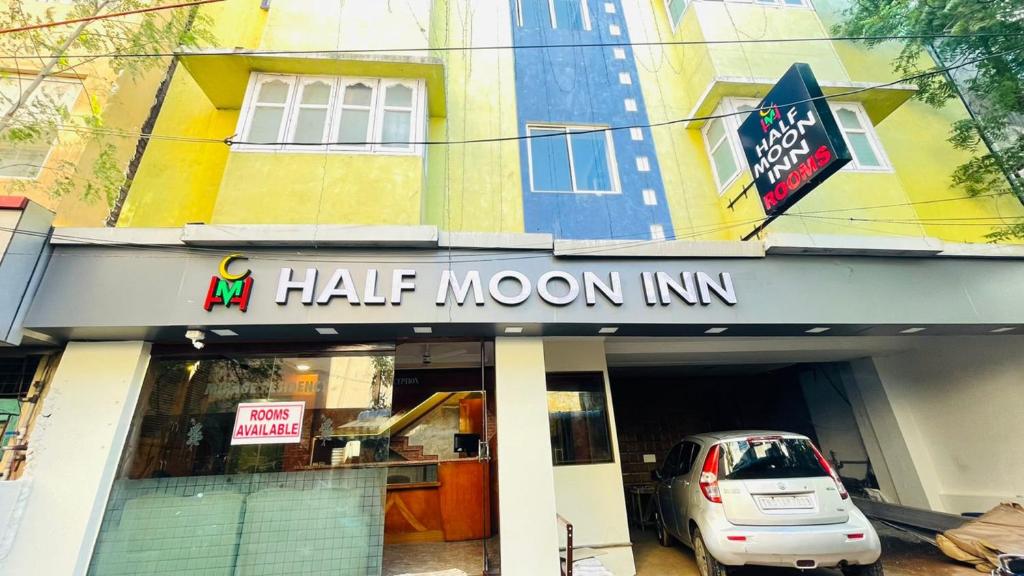 a half moon inn with a car parked in front at Half Moon Inn in Chennai