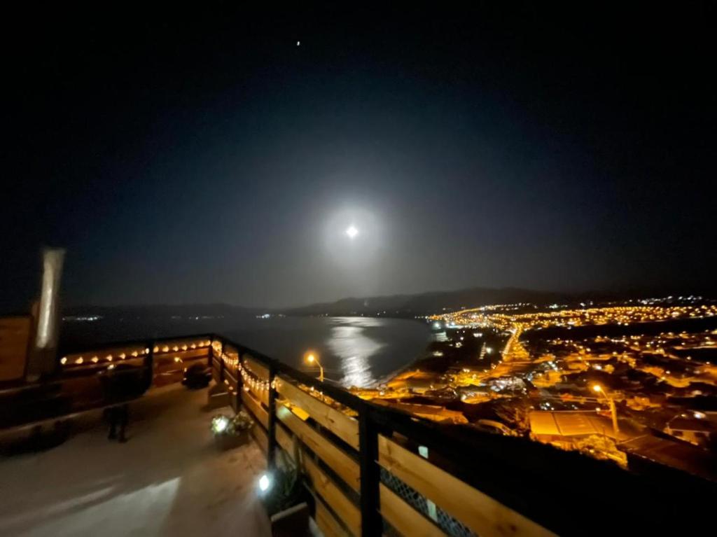 a view of the moon over a city at night at MIRADOR GUANAQUEROS in Guanaqueros