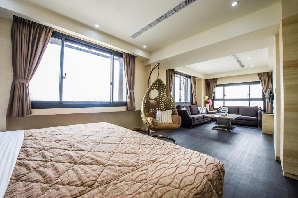 a hotel room with a bed and a swing at Red hotel in Yuanlin