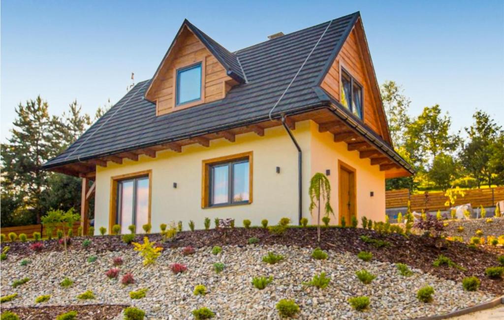 a house with a landscaping in front of it at 2 Bedroom Awesome Home In Lopuszna in Łopuszna