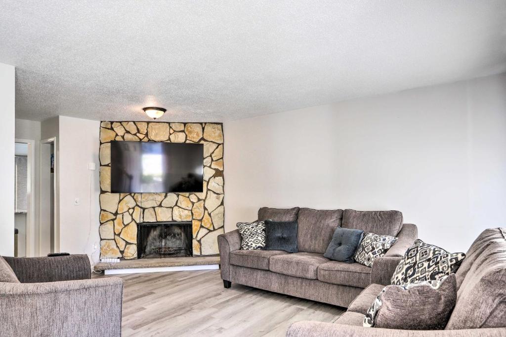 a living room with two couches and a fireplace at Bright Toledo Duplex, Close to Parks and Trails in Toledo