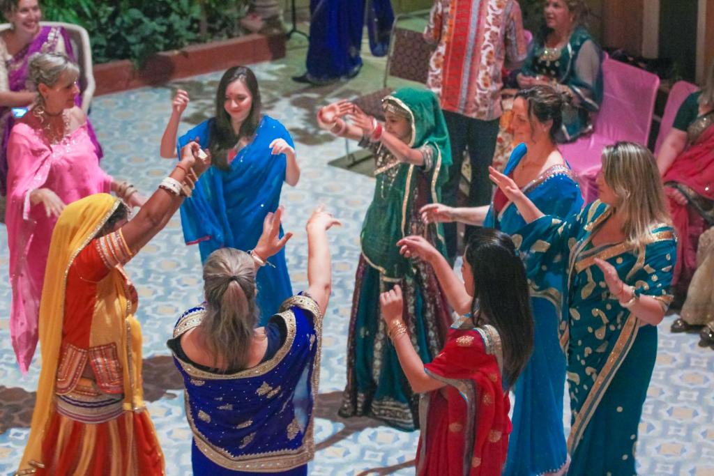 a group of women dancing at a wedding at Suryaa Villa - A Boutique Heritage Hotel in Jaipur