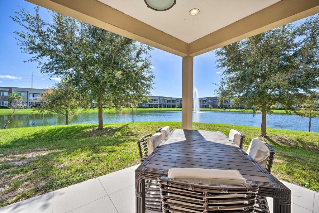 a table and chairs on a patio with a view of the water at Upscale Townhome Close to Walt Disney World! in Orlando