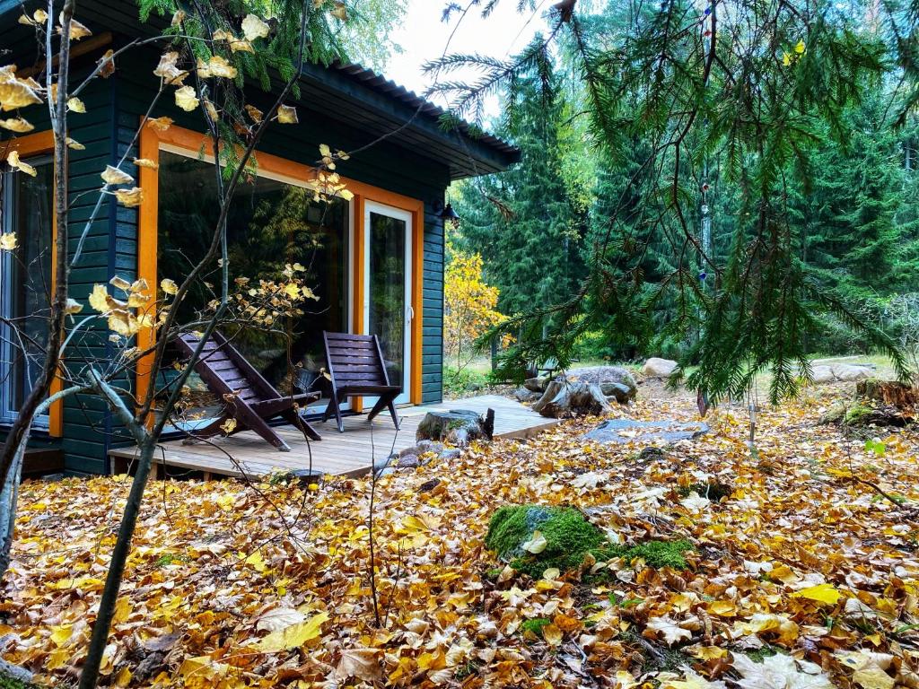 une maison avec une terrasse et une pile de feuilles dans l'établissement Ennu’s hut, à Loksa