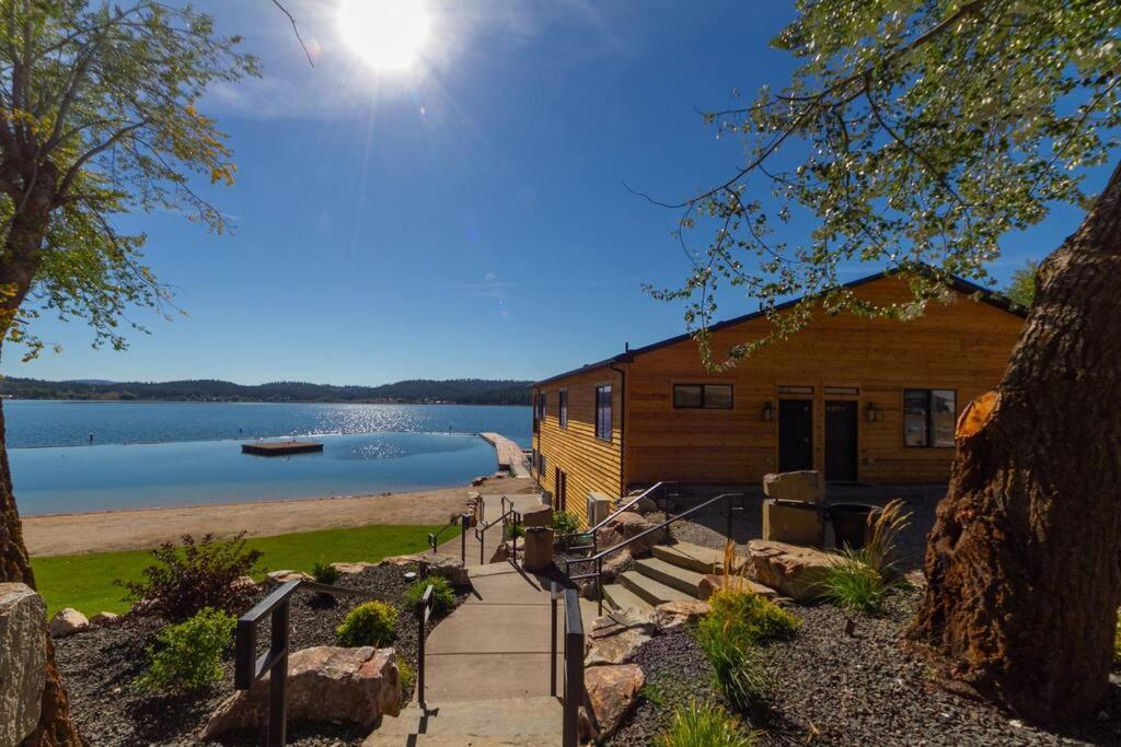 a log cabin on the shore of a lake at Gorgeous Triplex Unit With Spectacular Lake Views! in Valley