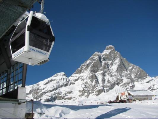 a ski lift in front of a snow covered mountain at Cervinia in residence in Breuil-Cervinia
