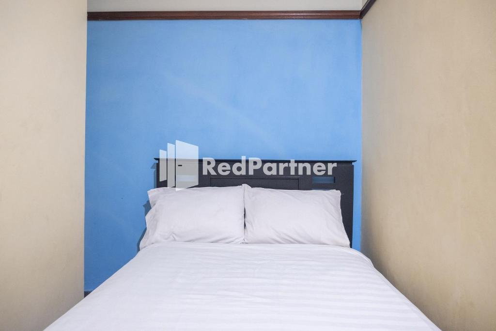 Postel nebo postele na pokoji v ubytování Athaya Hotel Syariah near UGM Yogyakarta Mitra RedDoorz