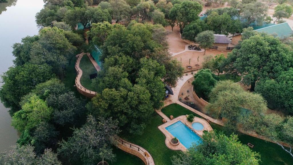 an aerial view of a park with a swimming pool at Kwadiwa Ranch in Baines Drift