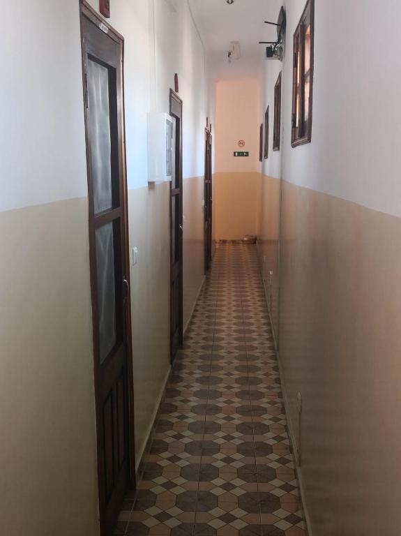 an empty hallway with a tiled floor in a building at Micaval Residential in São Tomé