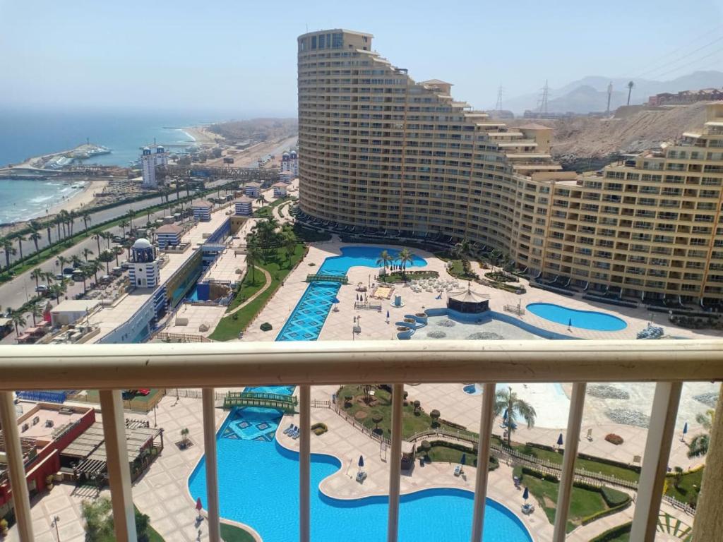 a view from a balcony of a resort with pools at Private Chalets in Porto Sokhna Pyramids - Families Only in Ain Sokhna