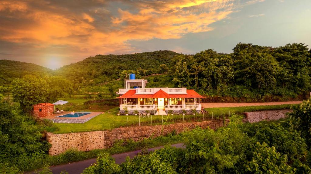 a house with a red roof on top of a river at Spicy Mango Ocean Paradise - Luxurious Sea View Villa In Alibaug in Christpāda