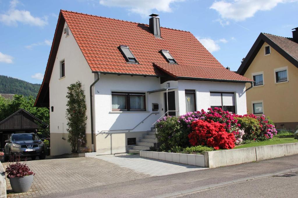 une maison blanche avec un toit orange dans l'établissement Ferienwohnung Aschoff, à Buhl