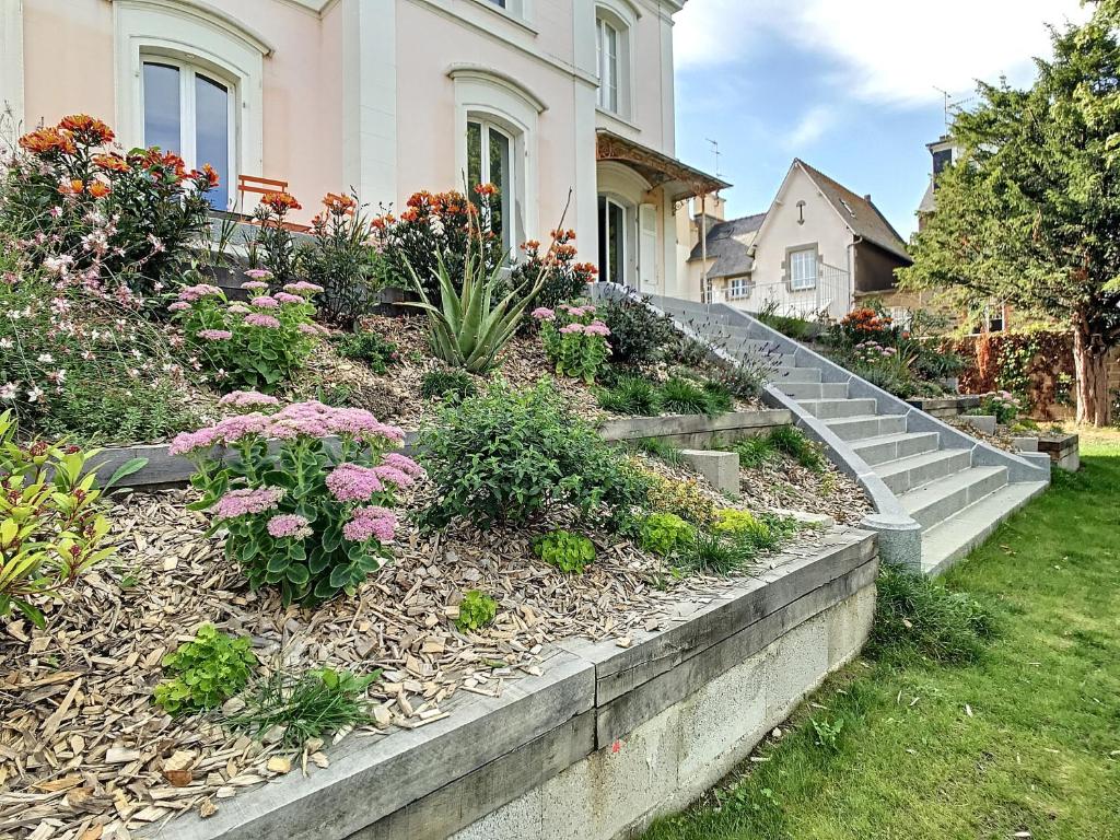 a garden with stairs in front of a house at Maison Lacase in Saint Malo