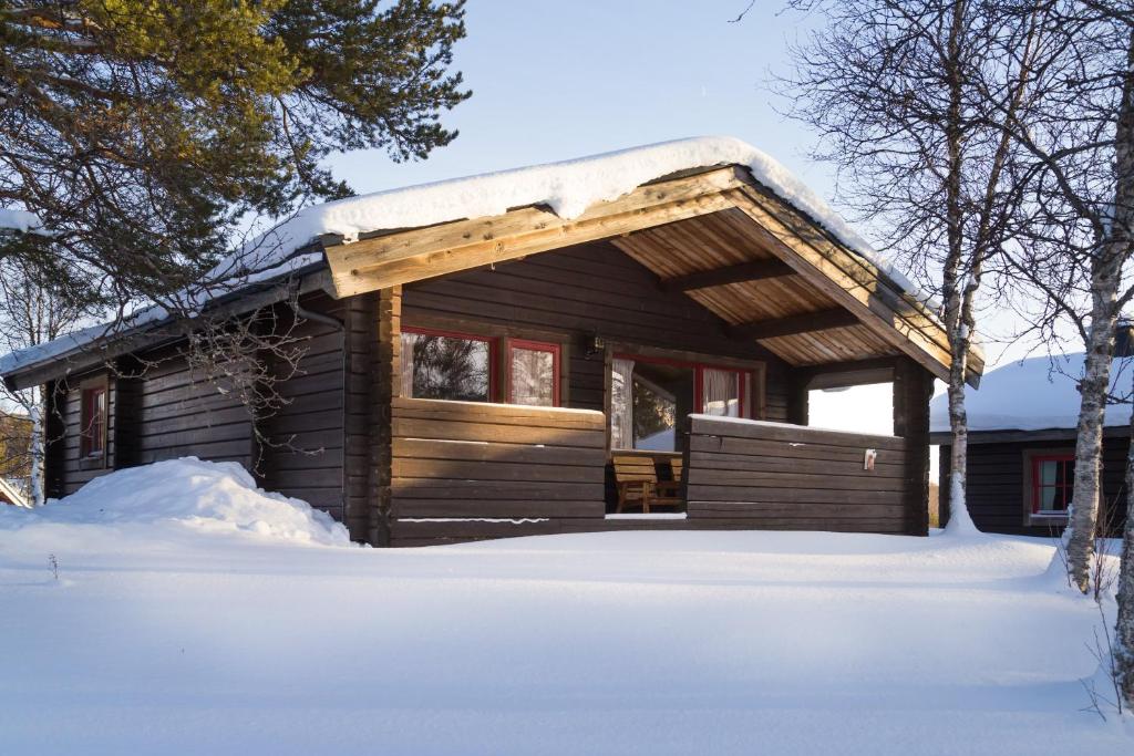 a log cabin in the snow with snow at Lullens Stugby - Stugorna 1-5 in Bruksvallarna