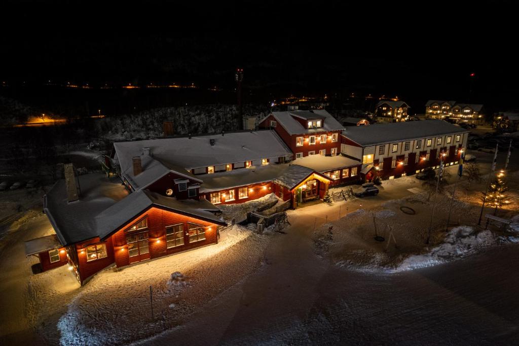 an aerial view of a large building with lights at Ramundbergets Fjällgård in Ramundberget