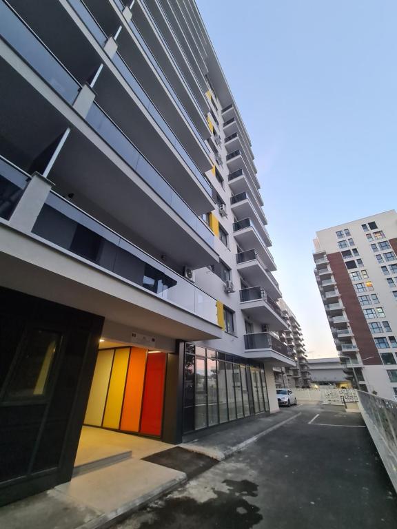 a building with colorful doors in a parking lot at Ghencea Residence 158 L2.2 in Bucharest