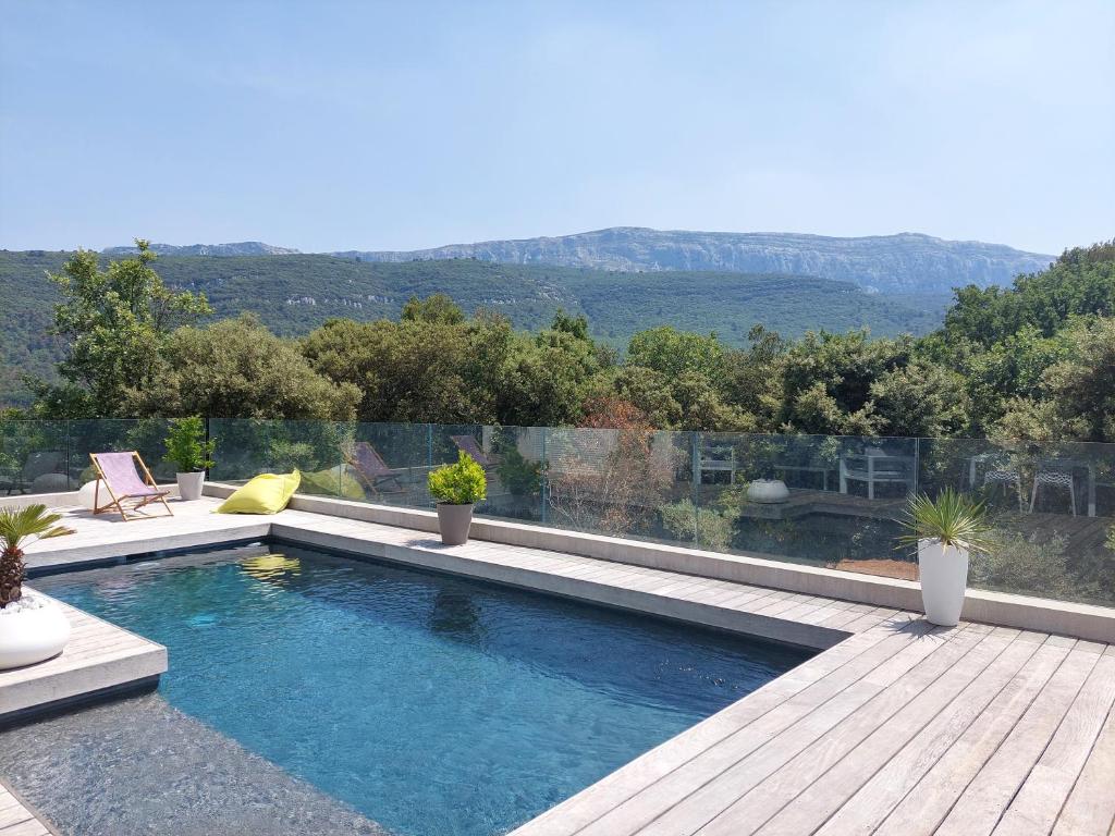 a swimming pool with a view of a mountain at Chez Herve et Lydie in Nans-les-Pins