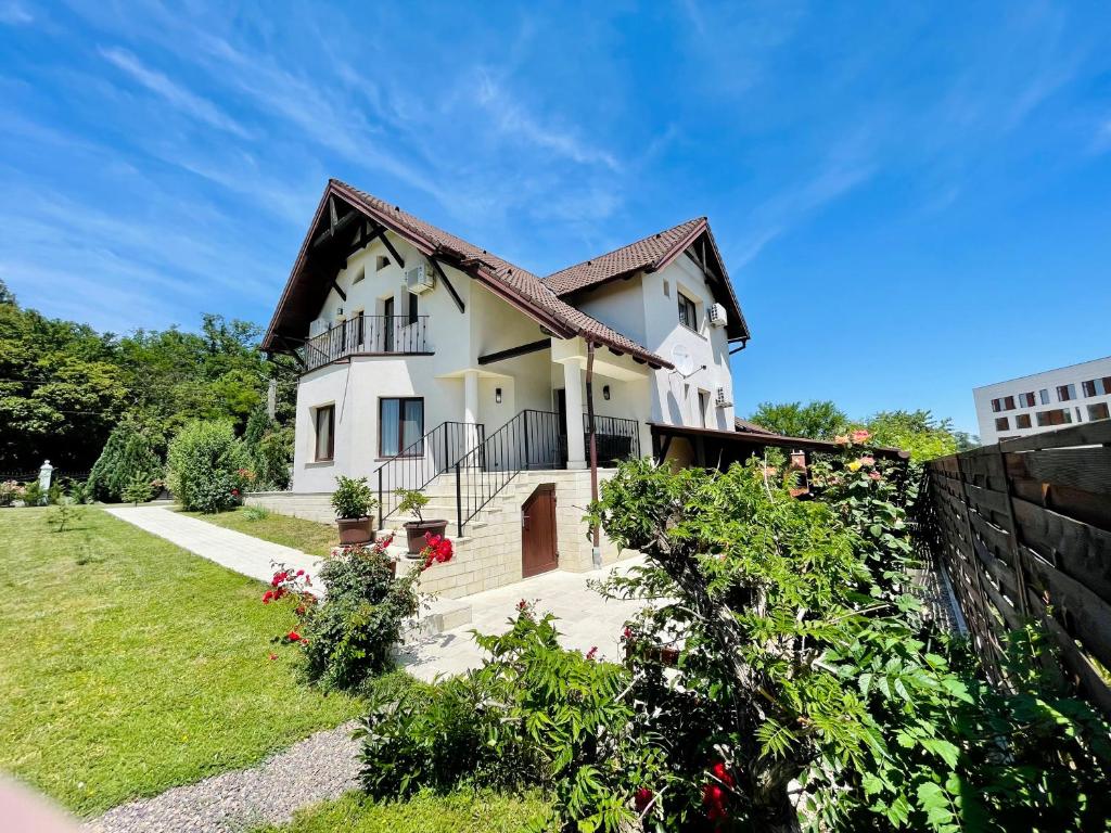 une maison blanche avec un toit marron dans l'établissement Hermesvilla, à Băile Felix