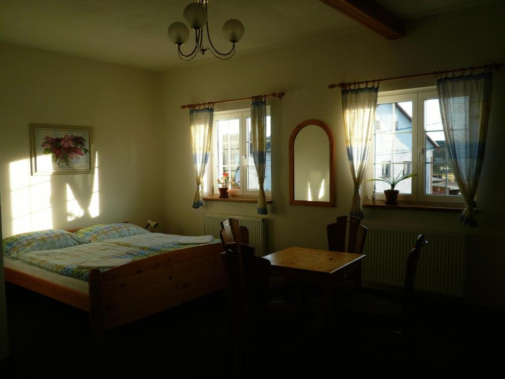 A bed or beds in a room at Penzion U Studánky
