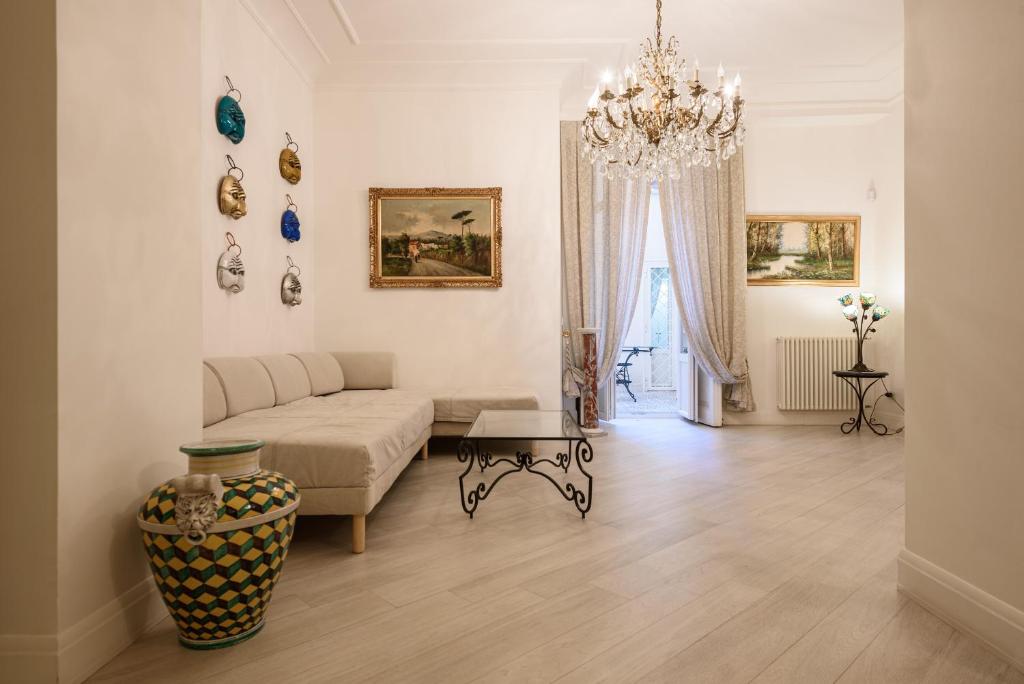 a living room with a couch and a chandelier at Palazzo dello Spagnolo Suite in Naples