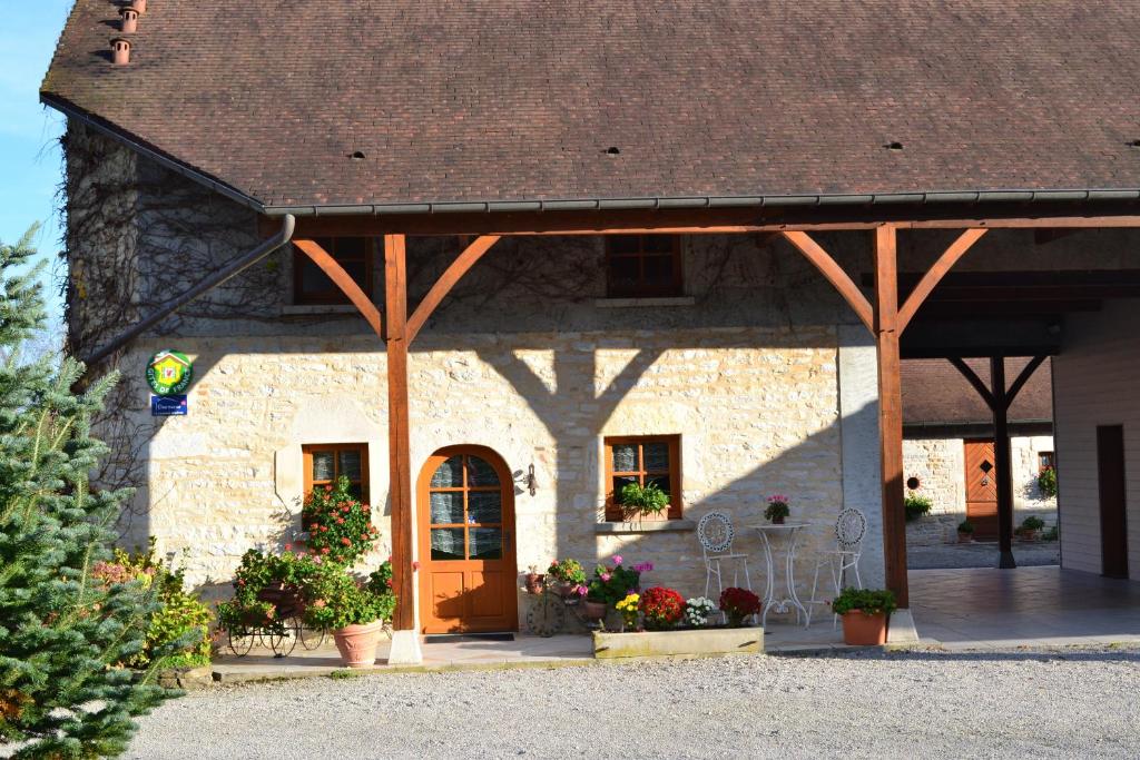 a large stone building with a brown roof at La Grange de Félix in Fontainebrux