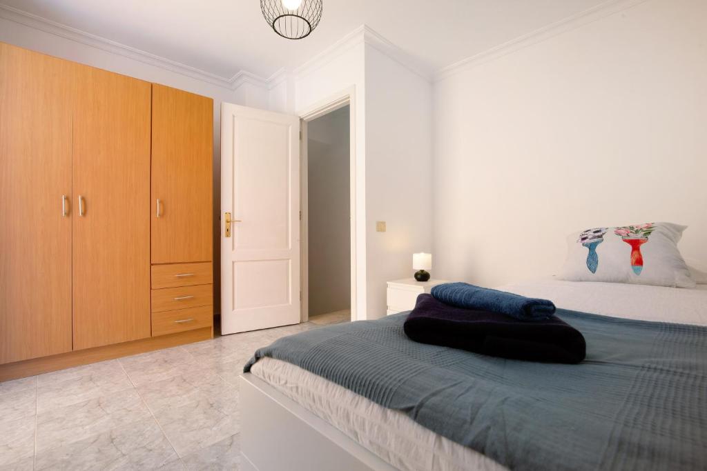 Łóżko lub łóżka w pokoju w obiekcie Apartamento Tanzanita