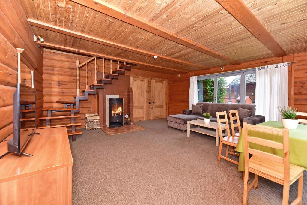 a living room with a staircase and a fireplace at Aerodream Trakai in Antakalnis