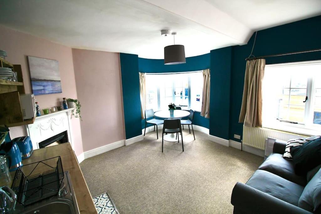 a living room with a couch and a table in it at Pier View 2 Bedroom Apartment in Cowes