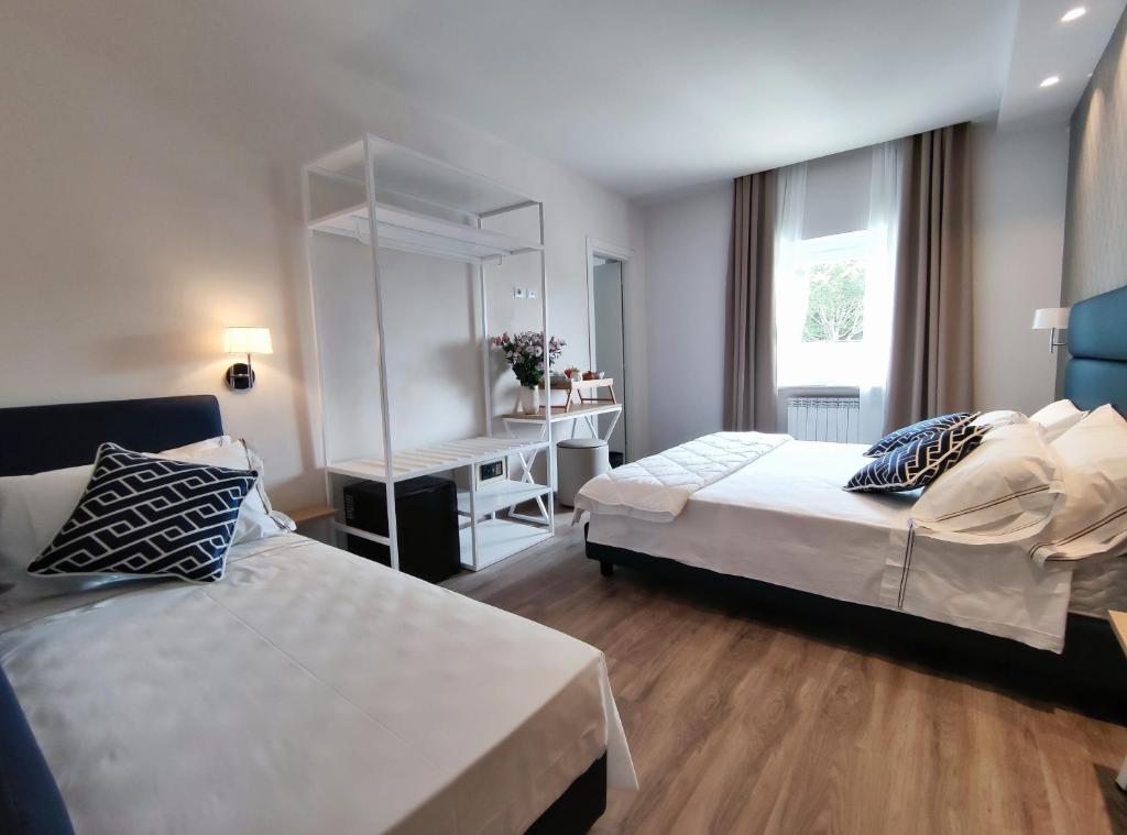 Postel nebo postele na pokoji v ubytování Hotel Valle del Fiora