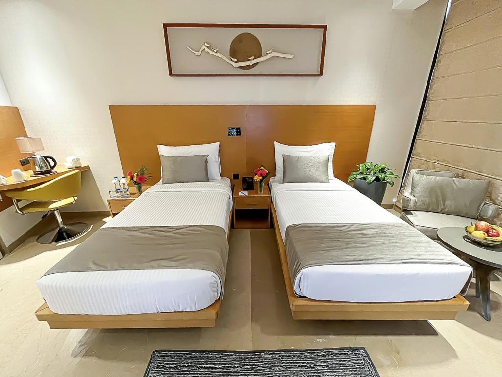 Postel nebo postele na pokoji v ubytování Morvee Hotels Alipore Kolkata