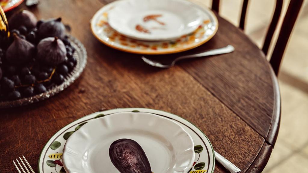 a wooden table with two plates and a spoon at Maison Saintonge in Paris