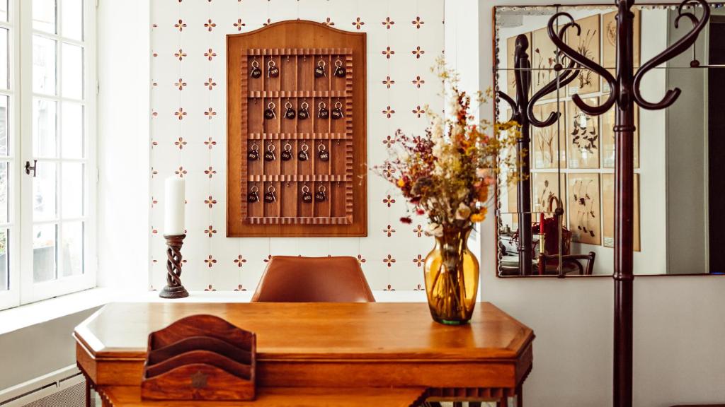 a dining room table with a vase of flowers on it at Maison Saintonge in Paris