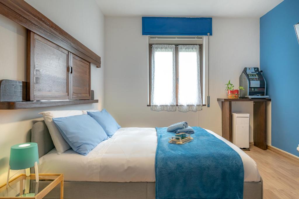 En eller flere senge i et værelse på Bilocale blue relax
