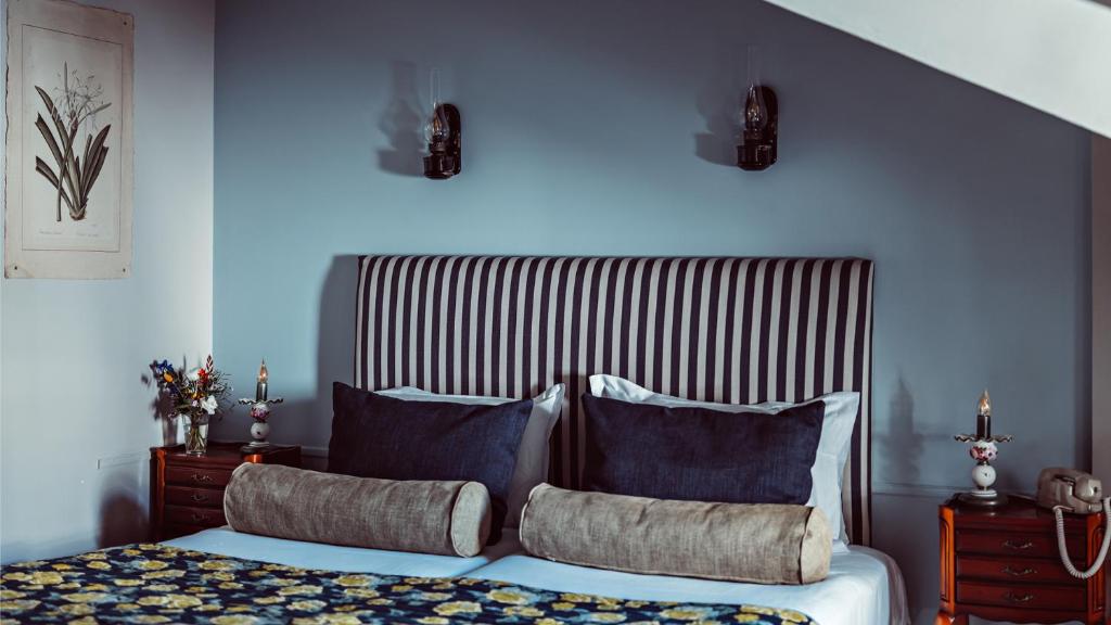 a bedroom with a bed with blue walls and blue pillows at Maison Saintonge in Paris