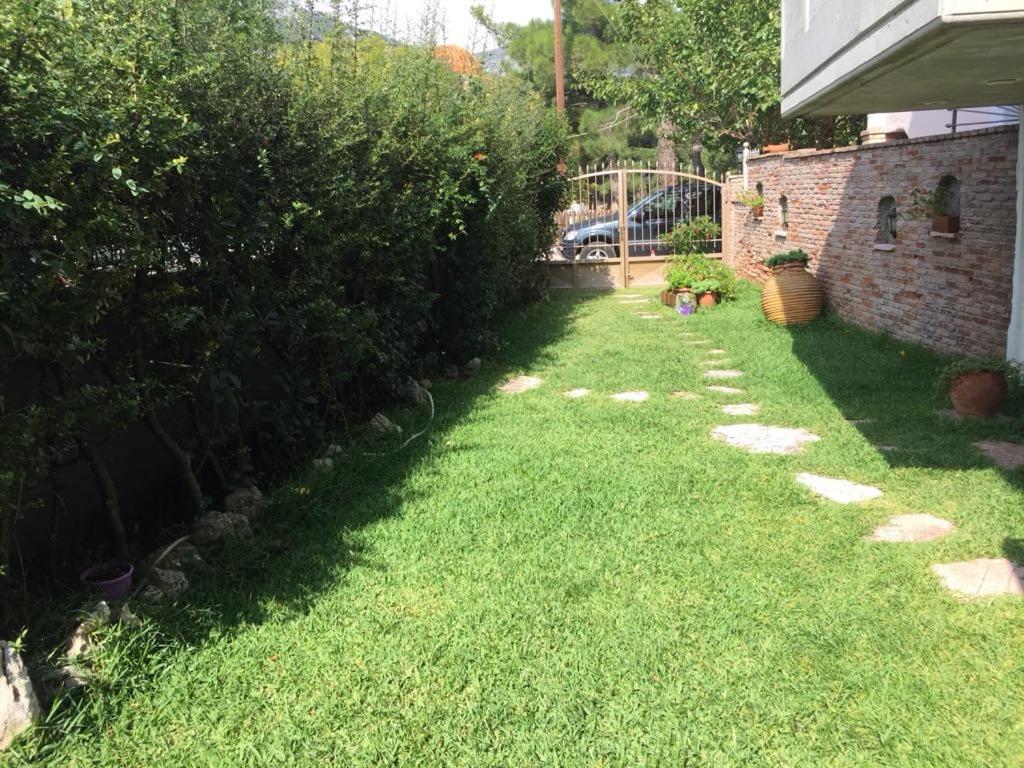 a backyard with a lawn with rocks in the grass at Villa Kallia's in Vília