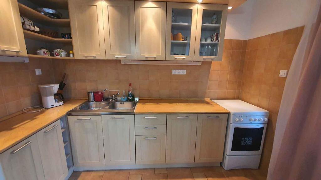 a small kitchen with a sink and a stove at Holiday home in Szantod - Balaton 43129 in Szántód