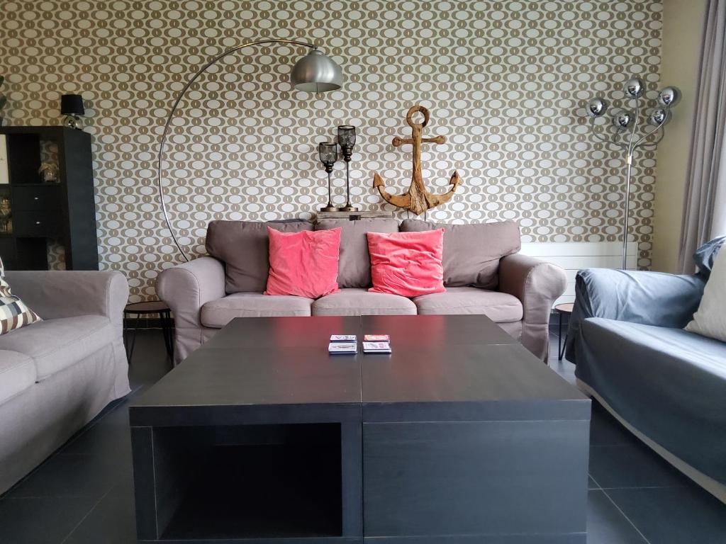 a living room with a couch and a coffee table at Vakantiehuis in Knokke-Heist met tuin en parkeerplaats in Knokke-Heist