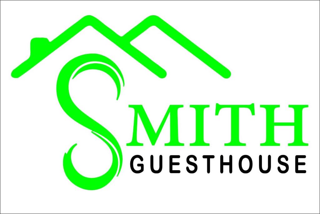 a green logo for a golf course franchise at Smith Guest House in Puducherry